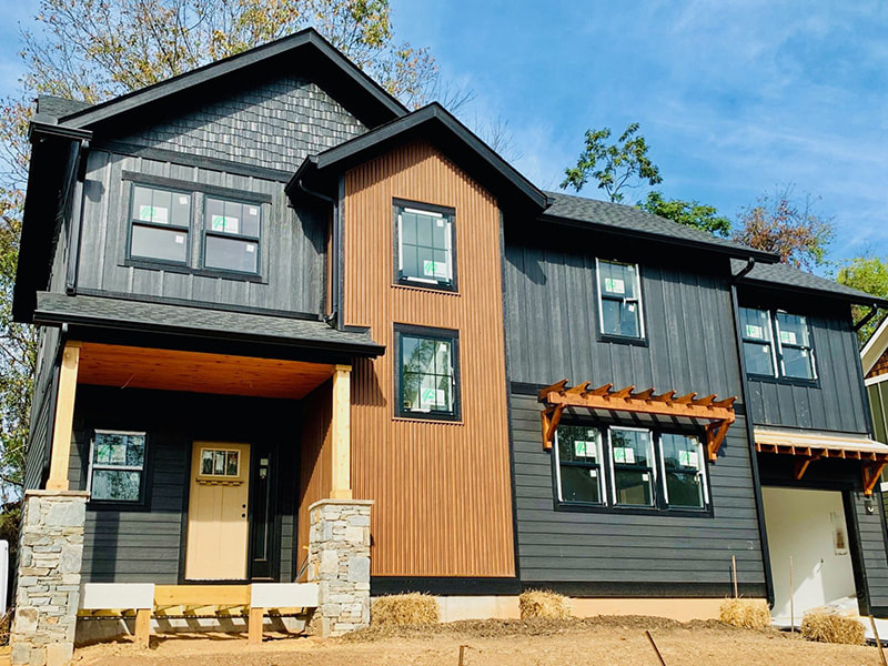 Contemporary black and cedar custom home built by Wanoca Builders